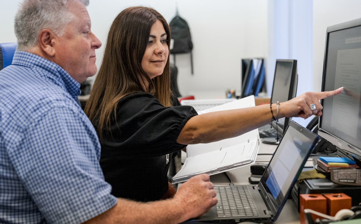 two-employees-looking-at-computer